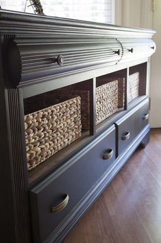 an old dresser has baskets on the drawers