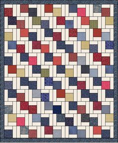 a quilt with many different colors and patterns on the front, along with a blue border