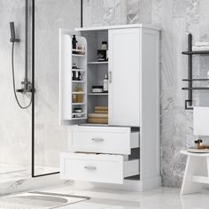 a white cabinet with drawers and shelves in a bathroom next to a bathtub, shower head and toilet