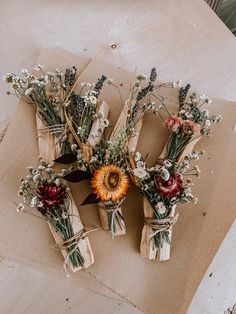 dried flowers tied together in twine on brown paper