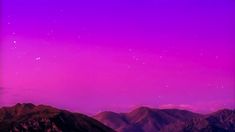 the night sky is pink and purple with mountains in the foreground, and stars above