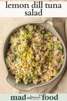 a bowl filled with tuna and broccoli on top of a white table cloth