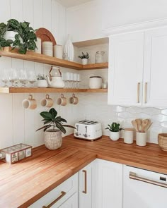 the kitchen is clean and ready for us to use it's counters are white with gold trim