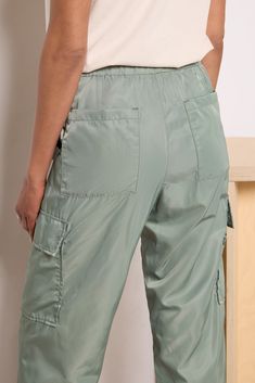 Dressed up or down, these Pistola pants will instantly upgrade your wardrobe. These chic cargo pants feature lightweight nylon fabric, an elastic tie waist with snap closure, and adjustable toggle hems to wear as a jogger or straight leg. Take them from day to night by swapping slides for strappy heels. | PISTOLA Women's Jade Lightweight Cargo Trouser Pants, Size Large, Green Utility Bottoms With Pockets For Travel, Nylon Cargo Pants With Side Pockets For Travel, Utility Travel Bottoms With Pockets, Nylon Bottoms With Pockets For Travel, Utility Travel Pants With Side Pockets, Utility Cargo Pants With Side Pockets For Travel, Nylon Cargo Pants For Travel, Travel Nylon Cargo Pants With Side Pockets, Travel Cargo Pants With Nylon Side Pockets