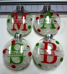 four personalized christmas ornaments hanging on the wall in front of a window with red, green and white polka dots