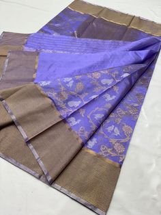 For any questions Whatapp Us: +4591718558 Visit www.silktatva.com for extra discounts Chanderi silk sarees are known for their sheer texture and light weight. This saree is woven with Copper zari handwork borders and elegant pallu to match in Pattu Silk. There are all over Copper zari and silver zari jaal in the body of the saree. The saree includes an unstitched blouse piece that matches the saree color and design.  The saree is 100% Pure Chanderi Handloom saree that comes with an assurance of Lavender Colour Silk Saree, Luxury Lavender Saree With Pallu Detail, Lavender Chanderi Saree, Purple Tissue Silk Saree With Zari Weaving, Lavender Kanjivaram Saree, Traditional Sarees