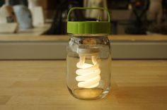 a light bulb in a mason jar on a table