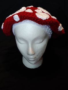 a white mannequin head wearing a red and white hat