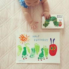 an image of a baby's hand and foot prints on a bed with the words happy birthday written in japanese