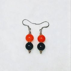 These are orange and black larger glass beads with silver accents. I can alternate the black and orange beads if desired. Great for Halloween or fall colors! These would make a unique addition to anyone's jewelry collection and make great gifts for friends and family! Glass Bead Earrings, Holiday Costumes, Halloween Black, Black And Orange, Cincinnati Bengals, Bead Earrings, Silver Accents, Glass Bead, Costume Party