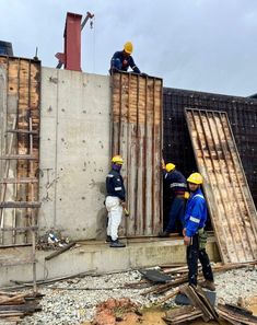 construction workers working on the side of a building