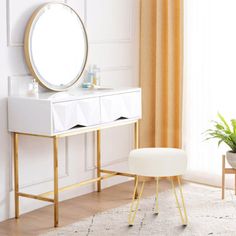 a white and gold dressing table with a round mirror on the top, two stools next to it