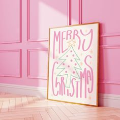 a pink room with a merry christmas sign on the wall next to it's wooden floor