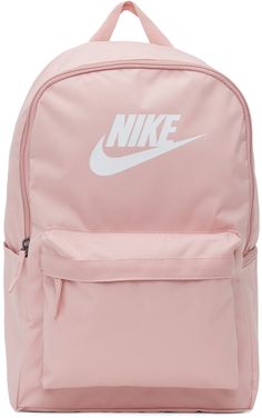 Canvas backpack in pink. Webbing carry handle at top. Twin adjustable padded shoulder straps featuring tonal textile logo flag. Bonded logo in white and zippered pocket at face. Zippered pocket and patch pocket at sides. Padded back face in black. Zip closure at main compartment. Laptop compartment at interior. Tonal textile lining. Gunmetal-tone and black hardware. Approx. 12.5 length x 18 height x 5.5 width. Supplier color: Pink Glaze/Black/White Pink School Bags, Pink Bookbag, Nike For Women, Pink Basketball, Nike Clothing, Birthday Gifts For Boyfriend Diy, Boyfriend Diy, Pink Canvas, Textile Logo