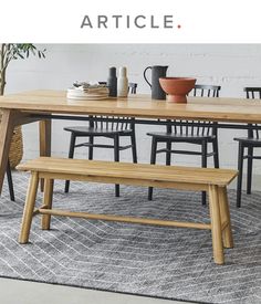 a wooden table with chairs and a bench in front of it that says article