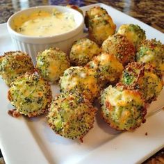 broccoli and cheese bites on a plate with dipping sauce