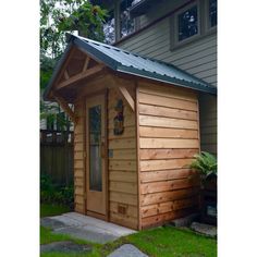 a small wooden shed with a metal roof