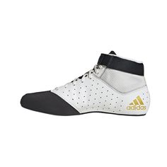 the adidas shoes are white and black with gold accents on the upper half of the shoe