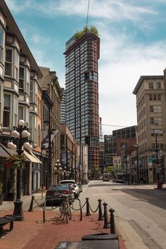 a city street with tall buildings in the background