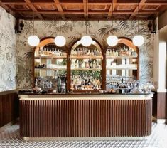 the inside of a restaurant with wooden ceilings and tiled flooring, along with bar stools