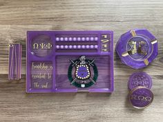 the purple tray is filled with different items and has gold trimmings on it