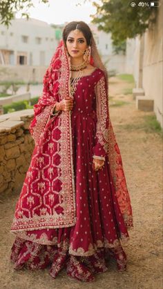 a woman in a red and gold bridal gown