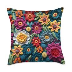 a colorful pillow with crocheted flowers on it