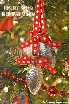 a christmas ornament hanging from a tree decorated with red and white polka dots