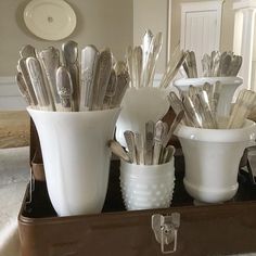 there are many spoons in the cup on the tray and one is silverware