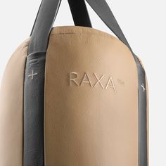 a tan and black bag with the word raxa printed on it's side