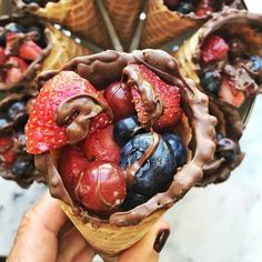 chocolate covered strawberries and blueberries in a cone