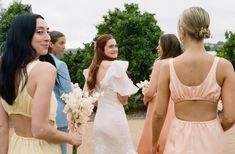 the bridesmaids are all dressed in pastel dresses