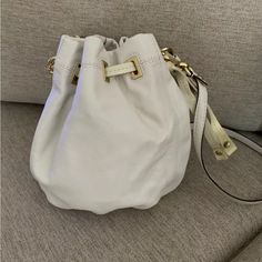 You Are Looking At A Brand New (With Tags) Authentic Coach Peyton Bucket Bag!! This Bag Is A Pretty Cream Color With Gold Hardware. It Has Patent Leather Strap That Is Even More Cream Colored That Cinches At The End To Close The Bag. This Bag Has A Top Handle And A Removable Crossbody/Shoulder Strap. The Clip That Makes The Shoulder Strap Removable Has “Coach” Written On Them And It Comes With A Patent Leather Coach Label Keychain Charm. The Inside Of This Bag Has A White With Gold Polka Dot Lin White Bucket Bag With Gold-tone Hardware For Travel, Coach White Soft Leather Bag, White Soft Leather Coach Bags, Coach Crossbody Bucket Bag With Removable Pouch, Coach Bucket Bag With Gold-tone Hardware, Coach Bucket Bag With Adjustable Strap, White Crossbody Bucket Bag With Gold-tone Hardware, Coach Bucket Bag With Adjustable Strap For Everyday Use, White Soft Leather Crossbody Bucket Bag