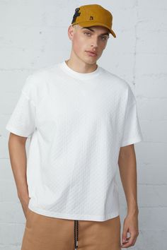 This boxy tee is crafted from jacquard checkered fabric, giving it a unique and stylish look. With a back yoke design, this tee offers a comfortable and flattering fit for any occasion. 96% Cotton 4% Spandex Models are 6'2" and wearing a size medium Relaxed Fit Textured Crew Neck Top, Textured Relaxed Fit Crew Neck Top, Everyday Textured Knit Short Sleeve Tops, Cotton Jacquard Knit Short Sleeve Tops, Oversized Jacquard Knit Crew Neck Top, Summer Jacquard Knit Crew Neck Top, Relaxed Fit Textured Cotton Tops, Casual Jacquard Knit Top With Relaxed Fit, Textured Cotton Tops With Relaxed Fit