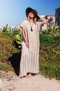 Whether you will wear it as an over-bikini cover-up, or as a dress on its own, you will be able to achieve an elevated look with our Collette Kaftan. Delicate and sophisticated, this linen kaftan will be a perfect fit at a resort by the sea, or at any poolside setting. You can also wear it as a tunic over a slip dress, shorts and even jeans. Collette Kaftan is one size. Due to its breathable transparency, you can purchase it together with our Leah cotton slip dress, that is available in sizes S, Beige V-neck Linen Dress For Beach, Chic V-neck Linen Beach Dress, Chic V-neck Linen Dress For Beach, V-neck Linen Dress For The Beach, Beachwear Maxi Dress With Side Slits For Beach Cover-up, Beige Maxi Dress For Beach Season, Linen Maxi Dress For Beach Cover-up, Beige Long Maxi Dress For Vacation, Long Beige Maxi Dress For Vacation