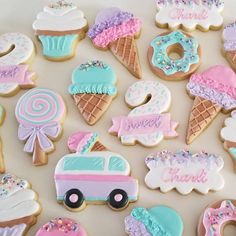 decorated cookies are arranged in the shape of ice cream, donuts, and cars