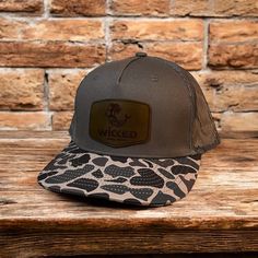 Vintage Duck Camo Five Panel Leather Patch Trucker Hat, Cascade. Five panel, duck camo bill, charcoal color cotton crown, charcoal mesh back, inside cotton sweatband, inside woven label.  Select or include the proper number for leather color and shape and attach logo in message field when ordering. Custom leather patch hats, custom patch hats, leather patch hats made in Texas. More duck camo hats on website along with Richardson and Yupoong custom leather patch hats. Blanks available on website. Custom leather patch hats made in Texas no minimum and wholesale custom patch hats. www.vonburtonsupplyco.com Duck camo trucker hats, duck camo hats, duck camo rope hats, vintage duck camo hats, custom leather patch hats Brown Military Trucker Hat, Brown Military Style Trucker Hat, Black Hunting Cap, Brown Snapback Trucker Hat For Hunting, Brown Military Hat, One Size Fits Most, Military Style Brown Baseball Cap, Brown 5-panel Hunting Hats, Cotton Crown, Camo Trucker Hat