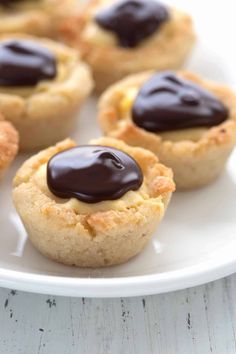 small desserts on a white plate topped with chocolate