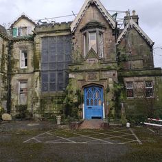 an old building with blue door and windows