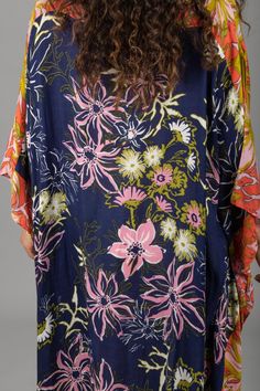 Our lovely Wildflower Kaftan showcases a range of floral motifs and delicate botanical elements in varying sizes and styles. The cinched sides of the garment create a unique drape that flatters all body types, enhancing natural beauty and complementing individual styles. The design also allows for easy movement, ensuring maximum comfort throughout the day. This kaftan, made from lightweight material, is the perfect choice for a luxurious and stylish outfit, whether you're lounging by the pool or Patterned Dresses With Kimono Sleeves For Summer, Multicolor Floral Print Beachwear Dress, Spring Rayon Floral Dress, Multicolor Tropical Print Floral Dress For Vacation, Multicolor Tropical Print Summer Floral Dress, Flowy Multicolor Floral Dress With Vibrant Print, Multicolor Flowy Floral Dress With Vibrant Print, Multicolor Hibiscus Print Spring Dresses, Flowy Rayon Floral Dress For Garden Party