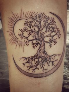 a tattoo with a tree and moon on it