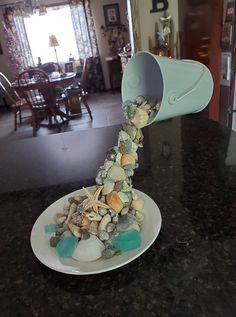 a white plate topped with rocks and shells