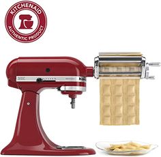 a red kitchen aid hand mixer next to a plate with crackers on it and a white background