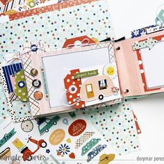 an open scrapbook with lots of papers and stickers on it's cover