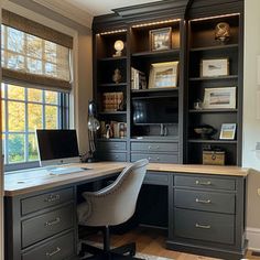 a home office with built - in desk and bookcases