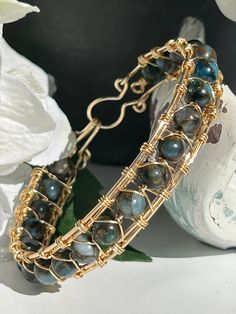 This boho bangle bracelet is inspired by the pure and natural beauty of the beach.  In fact, many of the products in my shop are handmade on the beach while savoring the cool breeze and calming ocean sounds. The gemstone, light blue imperial jasper, boasts a light blue and brown swirl pattern and is absolutely beautiful  This gemstone looks amazing with a pair of jeans or dressed up with a beautiful dress  Imperial Jasper is a nurturing gemstone that stimulates peace, serenity, and relaxation. I Bohemian Blue Crystal Bracelet With Gemstone Beads, Blue Bohemian Gemstone Bracelets, Bohemian Blue Crystal Bracelet Gift, Unique Blue Wire Wrapped Bracelets, Blue Copper Bohemian Bracelets, Boho Bangle Bracelets, Male Jewelry, Gemstone Bangle Bracelets, Boho Bangle