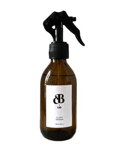 a brown glass bottle with a black sprayer on it and a white label that says b & b