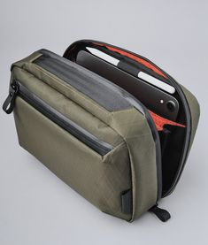 The Elements Tech Case Max is designed to keep you clutter-free and it can transform into a sling helping you stay hands-free when on the go. Easy access with plenty of internal space and exceptional organization to fit your daily needs. Can also be used as a desk organizer. Transforms into a sling bag (strap included) Accordion-style organization NEW: Slate Grey X-Pac® VX21 Dark Green X-Pac® VX21 Hot Orange X-Pac® VX25 Black X-Pac® VX21 100% carbon neutral Fits an iPad Mini 6 Fits a foldable he Functional Portable Cases For On-the-go, Multifunctional Rectangular Tech Accessories For Daily Use, Multifunctional Tech Accessories With Cell Phone Pocket, Multifunctional Travel Tech Accessories With Cell Phone Pocket, Multifunctional Rectangular Tech Accessories For Travel, Modern Rectangular Tech Accessories For Everyday Use, Functional Rectangular Protective Travel Case, Modern Portable Organizers For Everyday, Modern Portable Organizers For Everyday Use