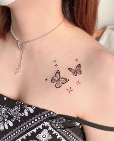 a woman with a butterfly tattoo on her chest