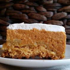 a piece of cake sitting on top of a white plate next to some pecans